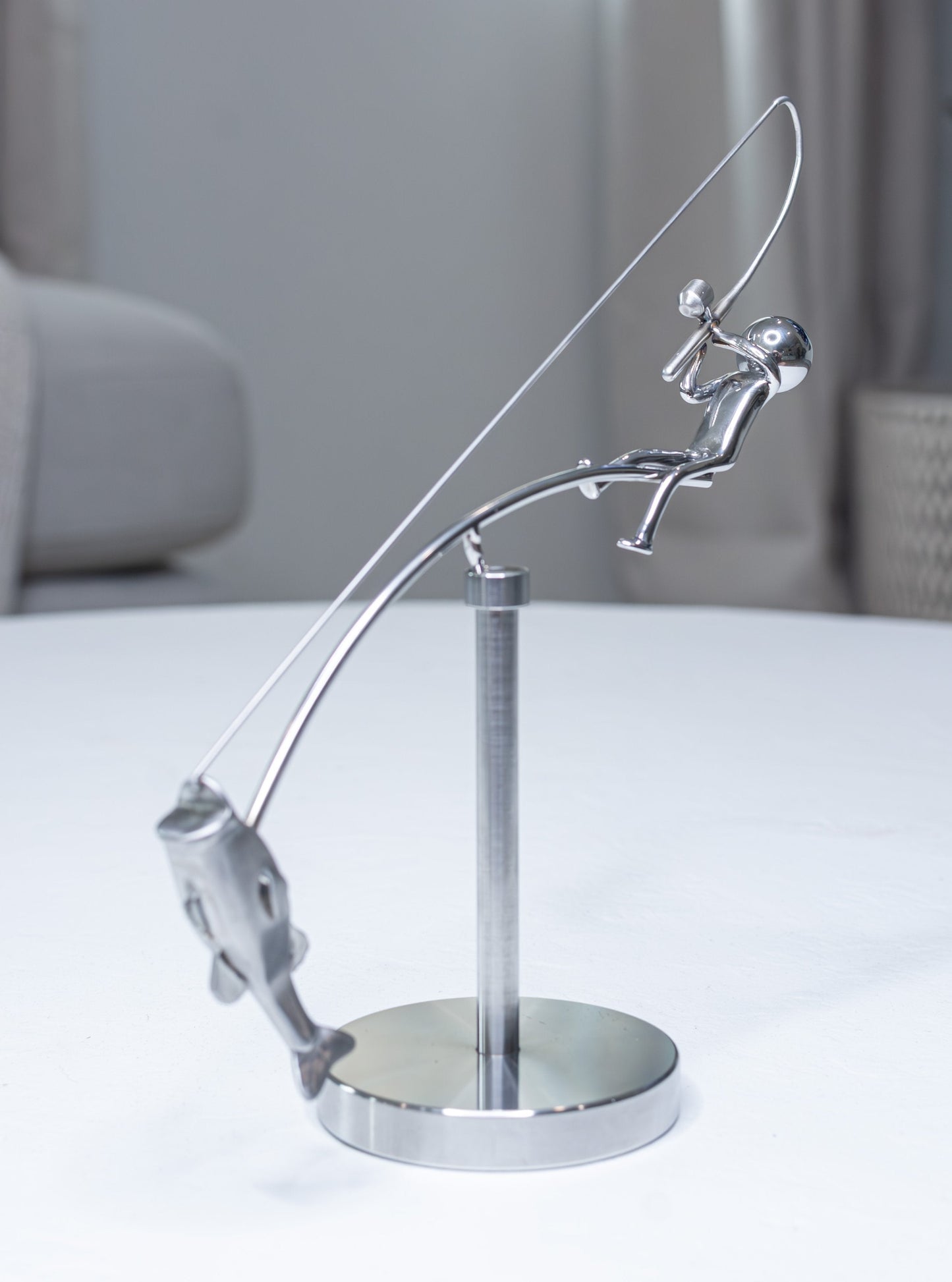 đŁFiskaren balanserar skulptur